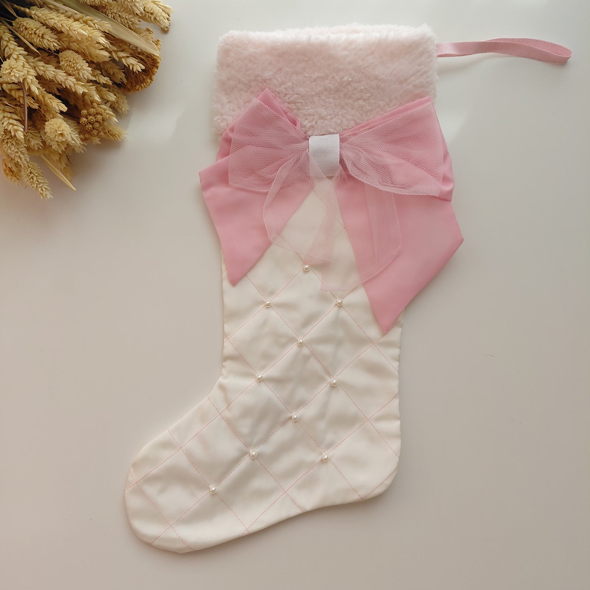 White Christmas stocking with a pink bow 