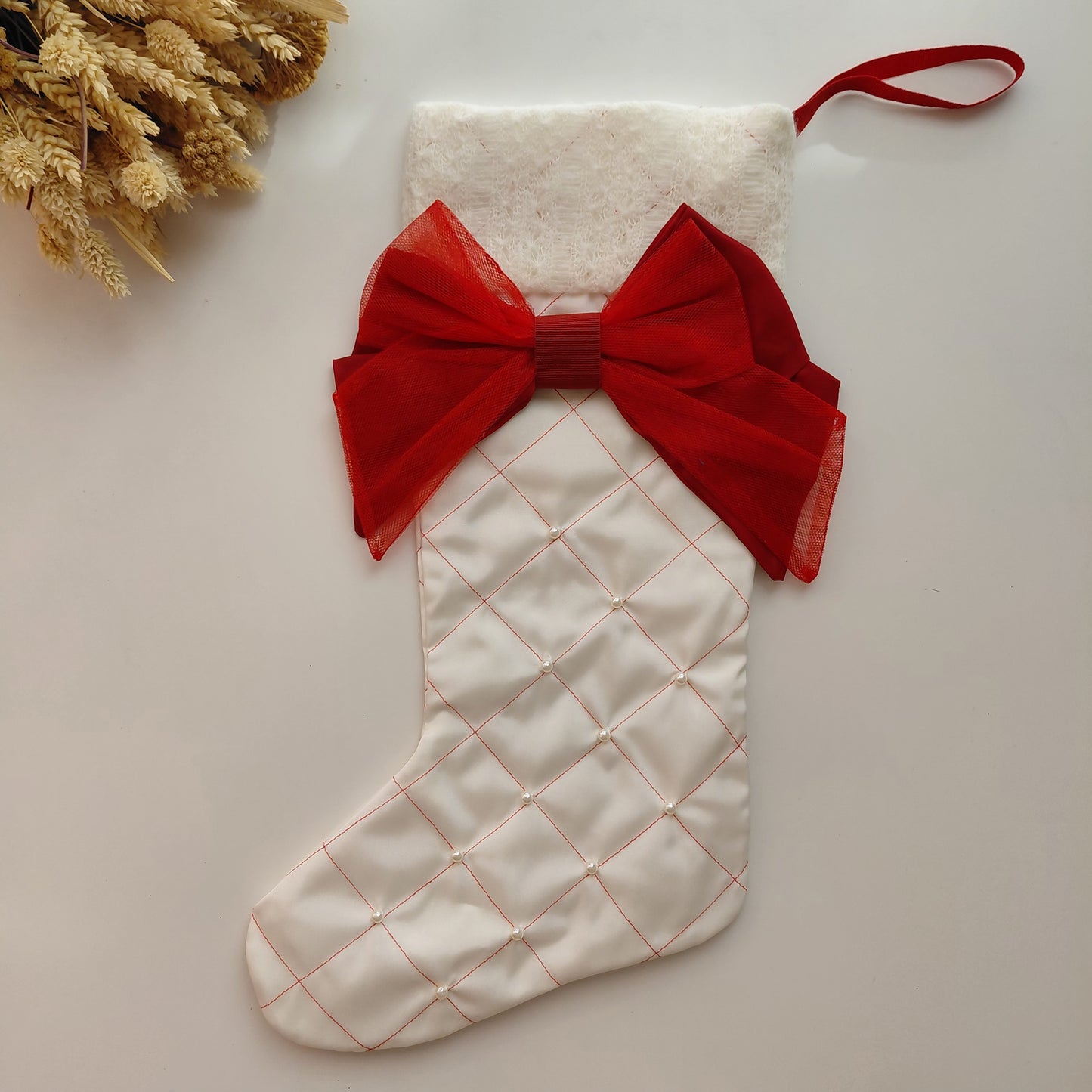 White Christmas stocking with a red bow 