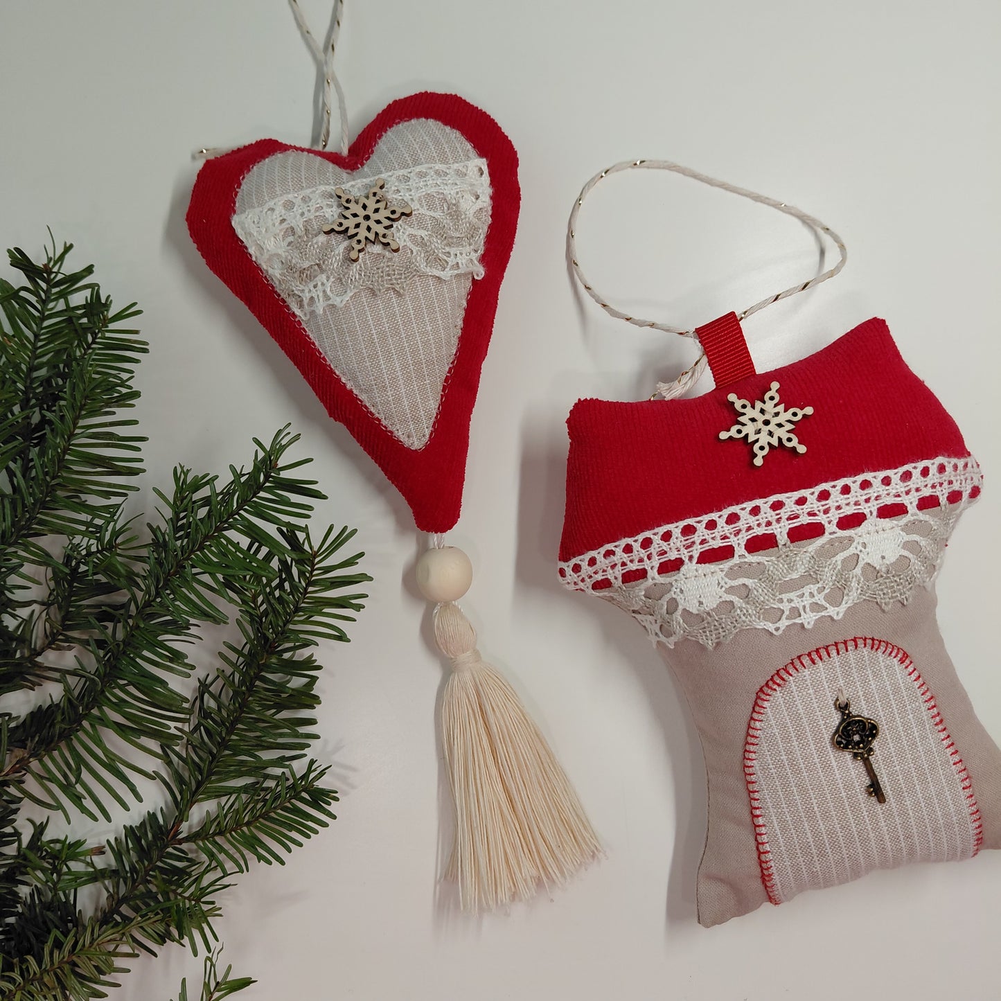 Red and white heart-shaped and door-shaped Christmas ornaments with lace details