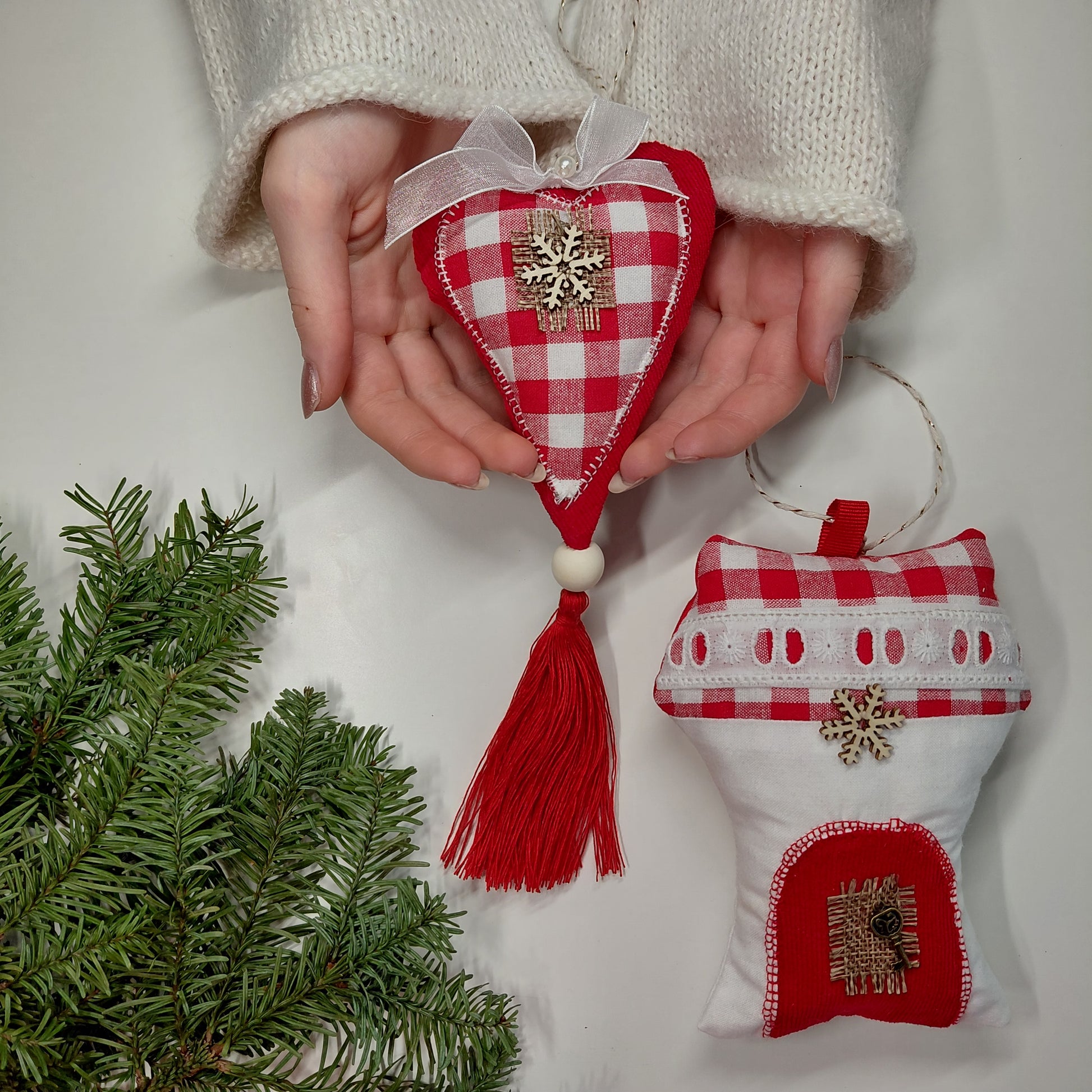 Red and white checkered heart-shaped ornament with tassel with a small house  ornament 
