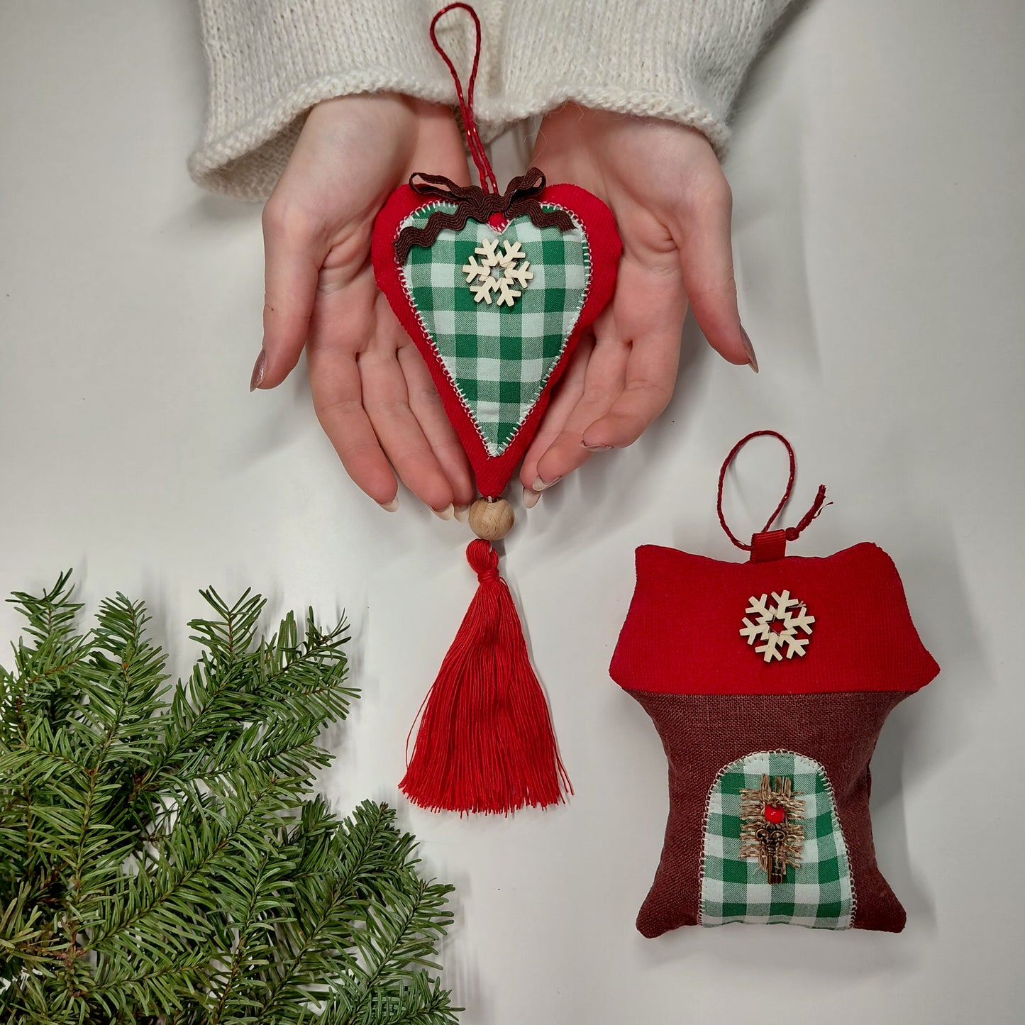 Heart-shaped and house-shaped Christmas ornaments with tassels and snowflake decorations 